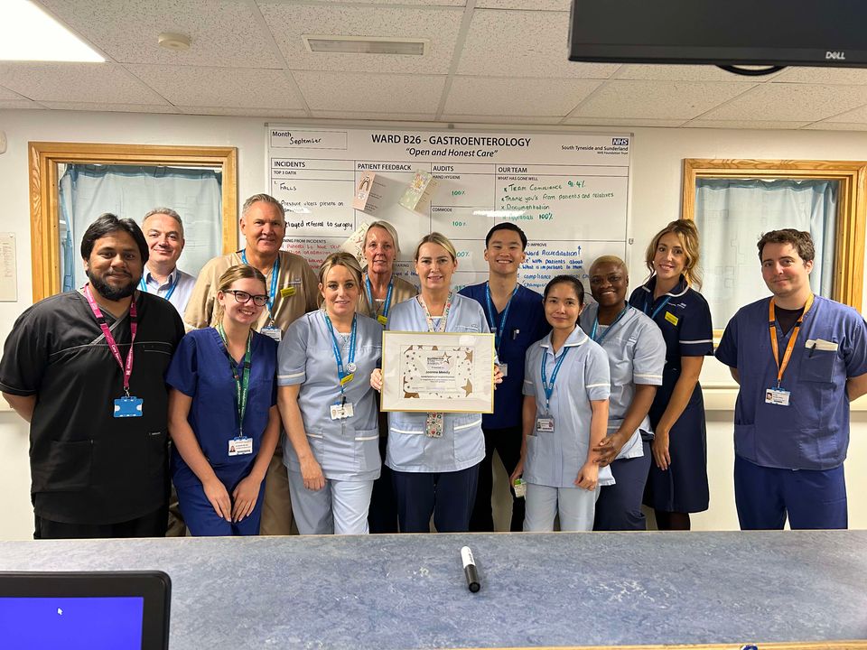 A group of people looking at the camera holding a certificate