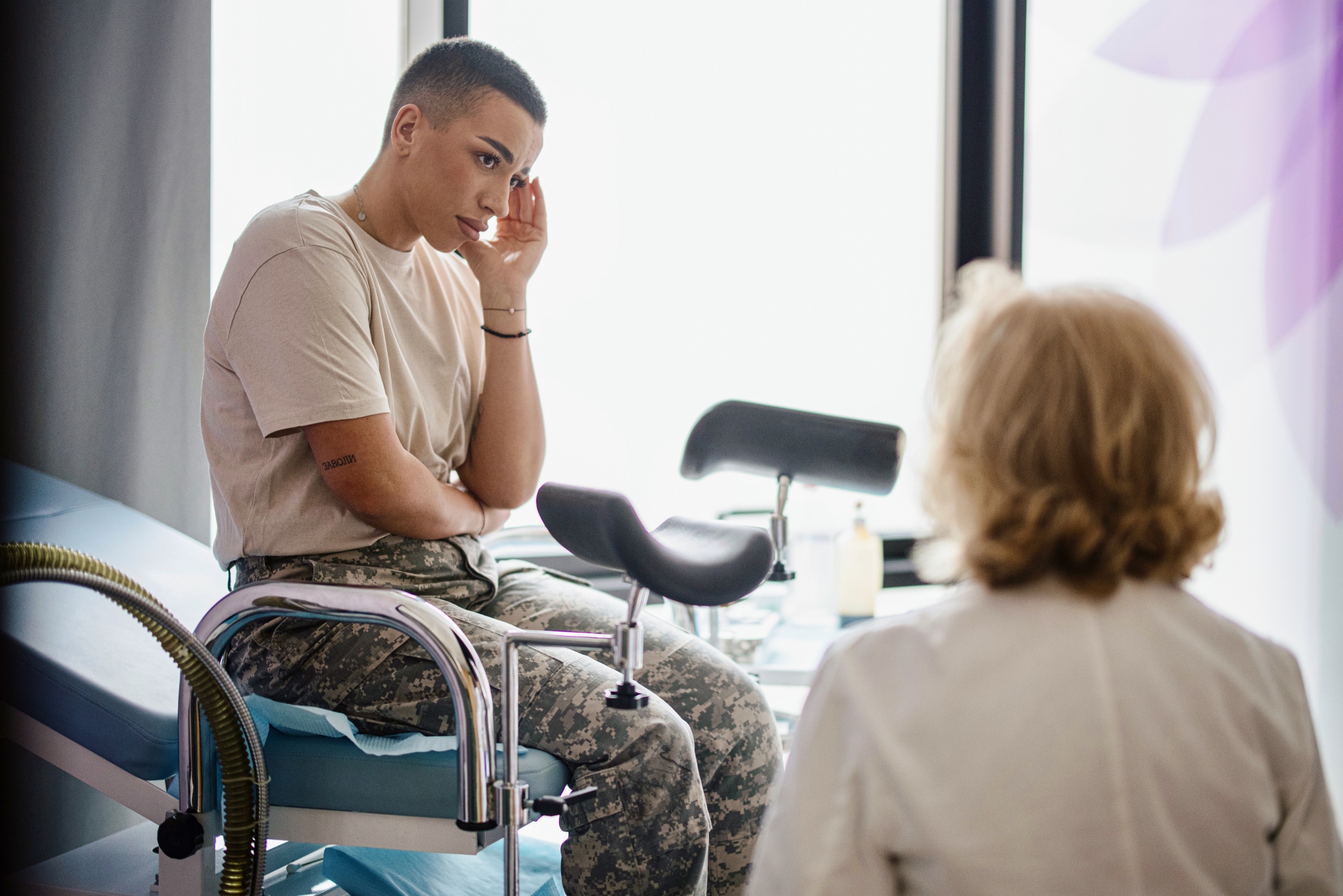 A woman with a doctor in an exam room