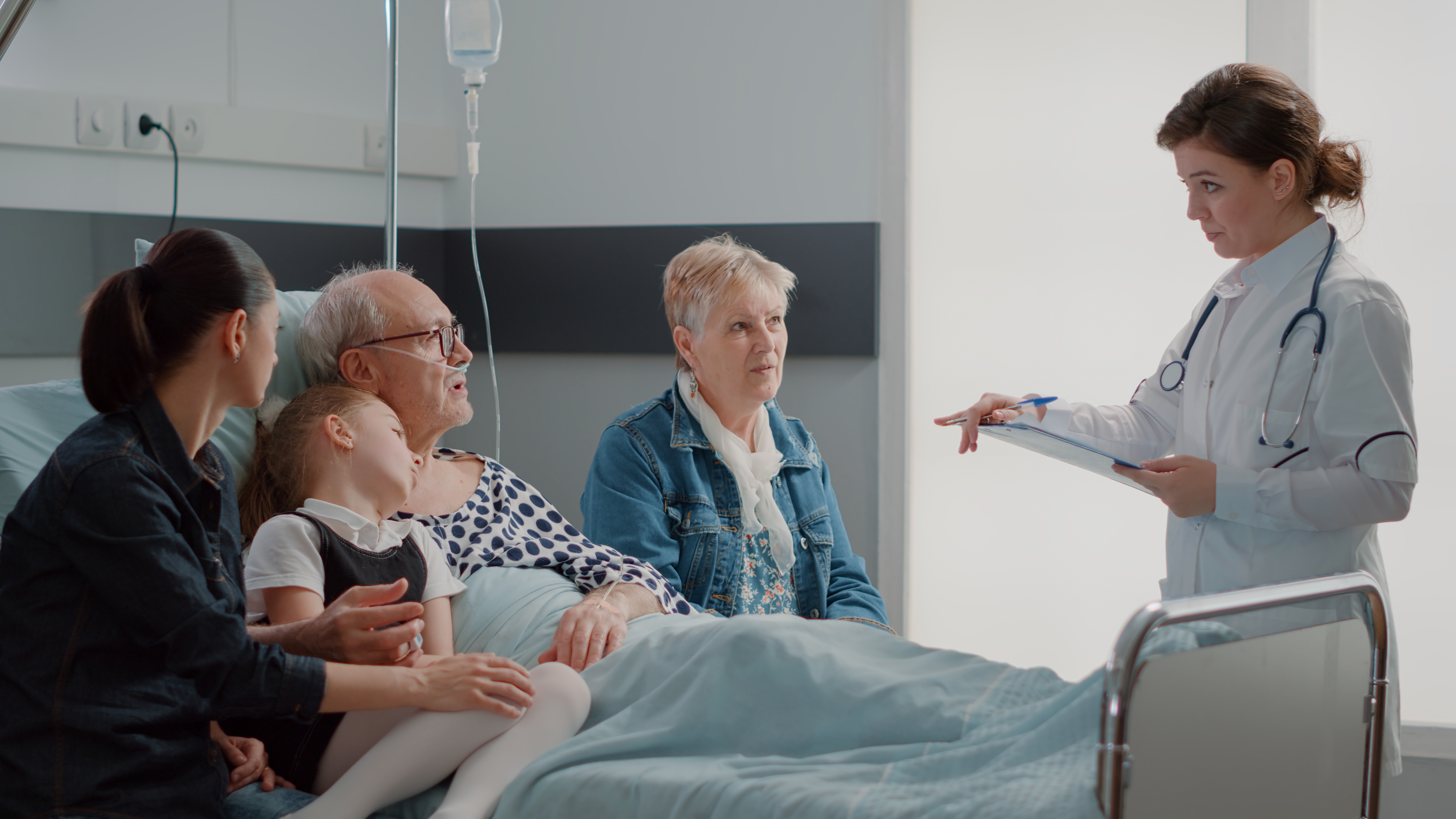 A nurse talking to a patient in a hospital bed