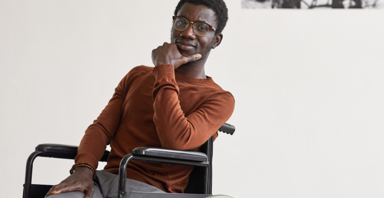 A young gentleman in a wheelchair looking at the camera