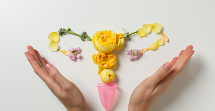 Picture of flowers arranged as a womb being held by two hands