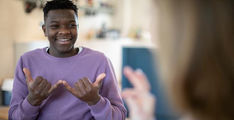 Teenage boy and girl having a conversation using sign language