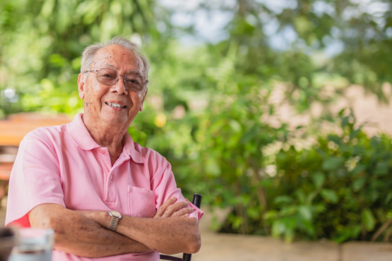 A gentleman standing smiling at the camera