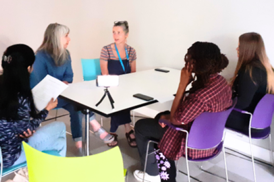 A group of women sitting at a table talking